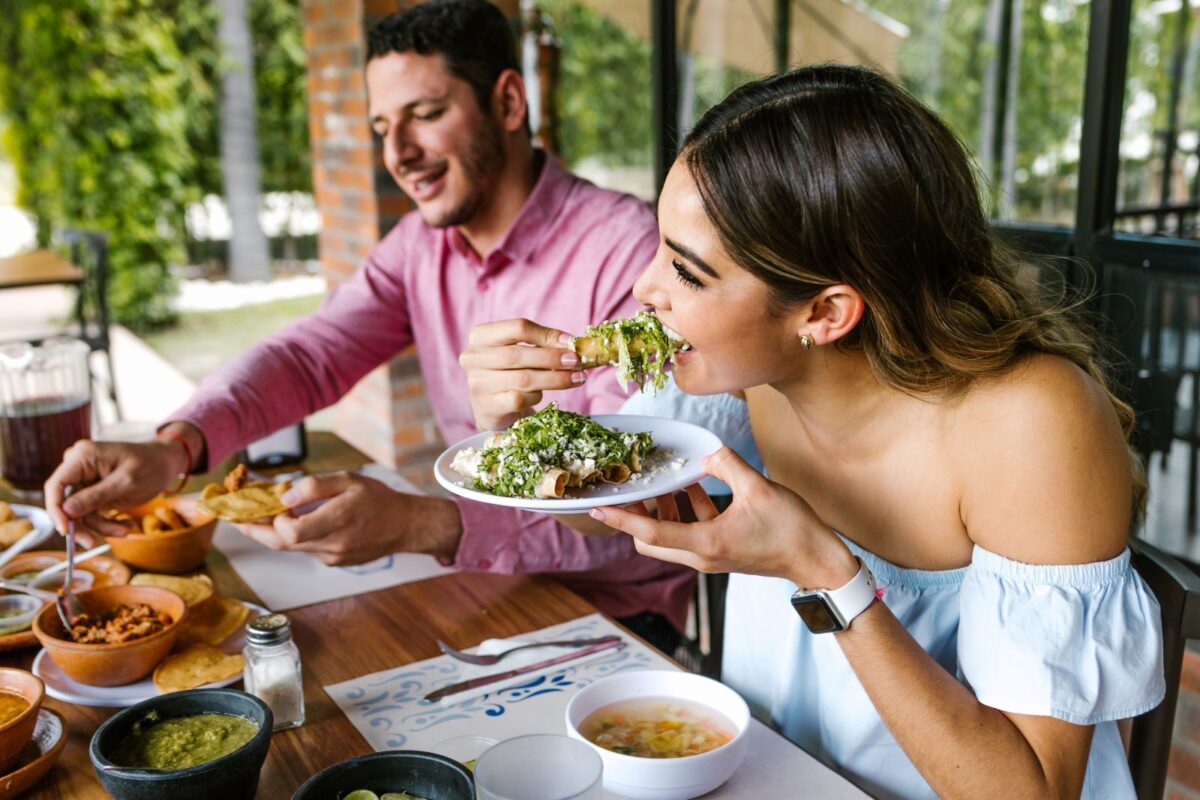 Man and woman eating Mexican food