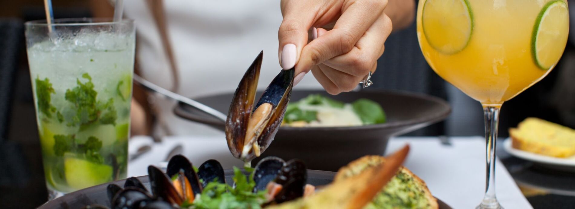 woman eating mussels